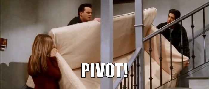 Chandler, Ross and Rachel pivoting the couch up the stairs in Friends