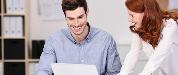 Happy Young Business Couple Watching Something at Laptop Computer on Top of the Office Table.-551166-edited.jpeg