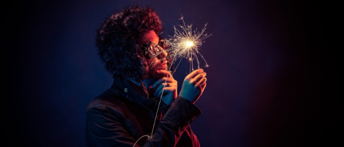 Man in sunglasses holding a sparkler