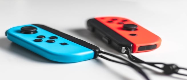 Blue and red gaming console controllers