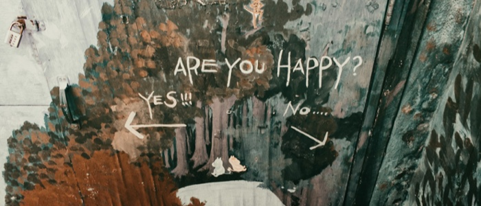 Graffiti wall which reads "Are you happy"